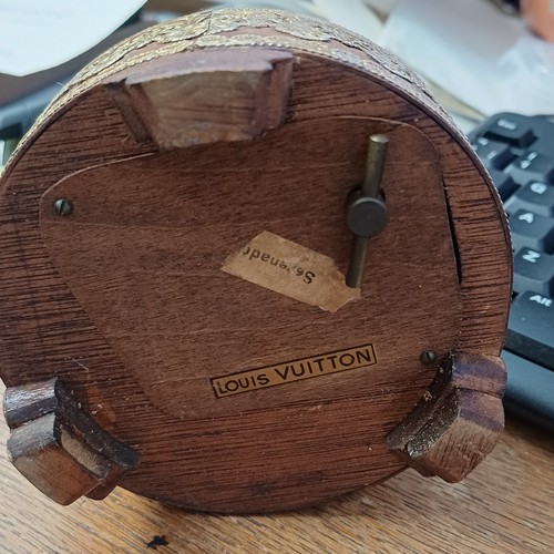 118 - Louis Vuitton. This vintage music box automaton features a miniature doll under a glass dome and is ... 