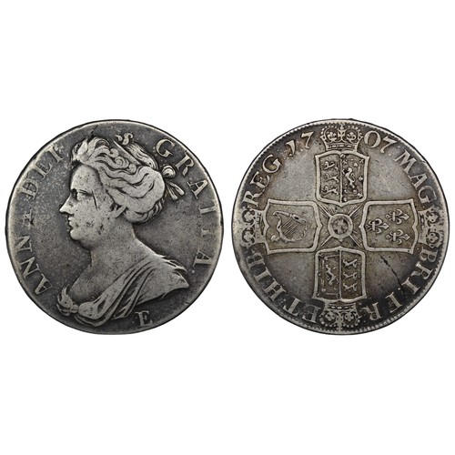 125 - 1707E Crown, Queen Anne. Edge SEXTO, Edinburgh mint with E below second bust. Reverse legend MAG : B... 