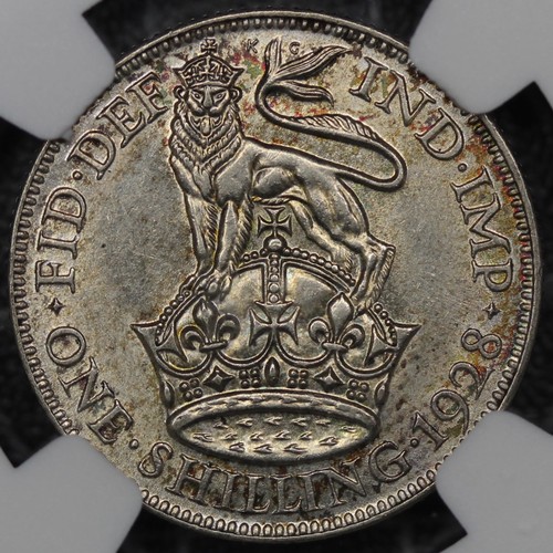 81 - 1928 Shilling, George V. Obv. bare head facing left, Rev. lion passant on crown. Graded NGC AU58. EF... 