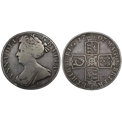 137 - 1707E Crown, Queen Anne. Edge SEXTO, Edinburgh mint with E below second bust. Reverse legend MAG:BR:... 