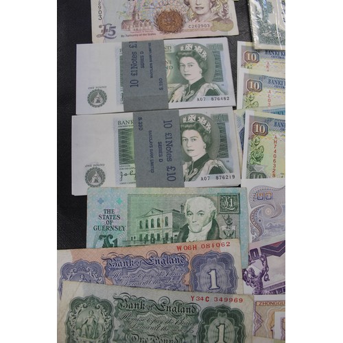 19 - Approximately 100 UK & world banknotes in mixed conditions to include two wrapped and aUNC £1 se... 