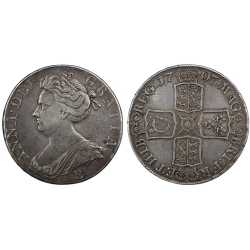 112 - 1707E Crown, Queen Anne. Edge SEXTO, Edinburgh mint with E below second bust. Reverse legend MAG:BRI... 