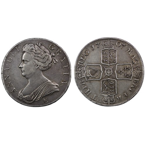 111 - 1707E Crown, Queen Anne. Edge SEXTO, Edinburgh mint with E below second bust. Reverse legend MAG:BRI... 