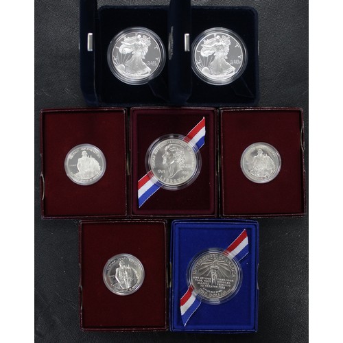 174 - America silver dollar and half dollar assortment (7) comprising 1982 George Washington half dollar (... 