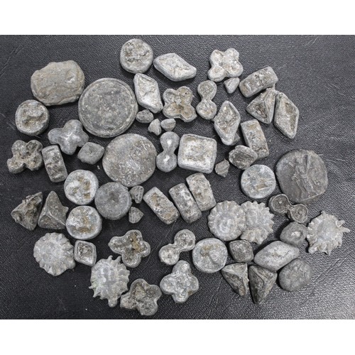 187 - A miscellaneous assortment of lead plaquettes. Of unknown origin or reason they form a variety of si... 