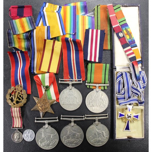 76 - An assortment of WWII medals, ribbons and badges to include the Defence Medal (2), 1939-1945 Medal (... 