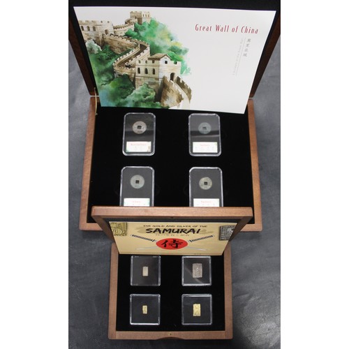 320 - A pair of oriental coin sets including 