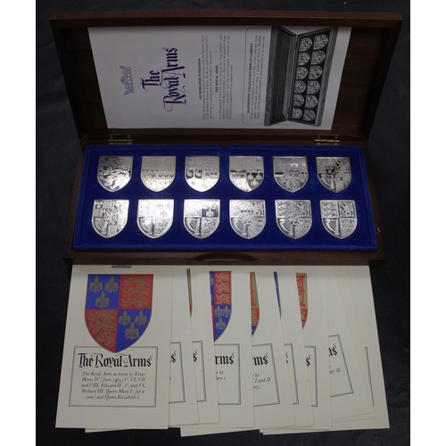 302 - The Royal Arms; a collection of 12 sterling silver reproductions of the Royal Coat of Arms from fami... 