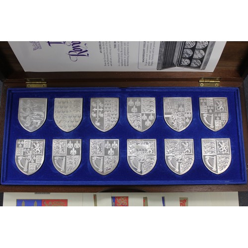 302 - The Royal Arms; a collection of 12 sterling silver reproductions of the Royal Coat of Arms from fami... 