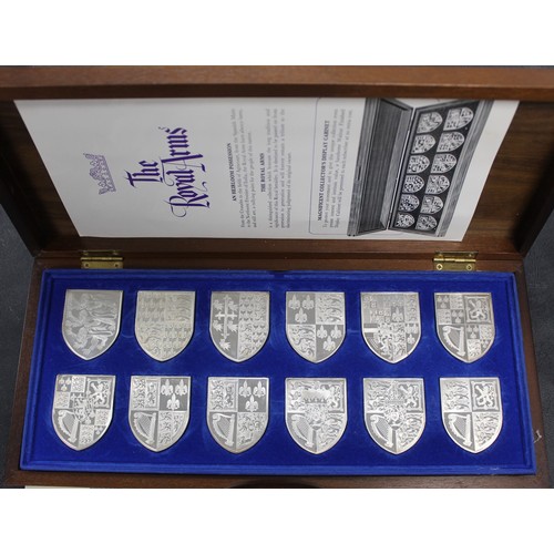 302 - The Royal Arms; a collection of 12 sterling silver reproductions of the Royal Coat of Arms from fami... 