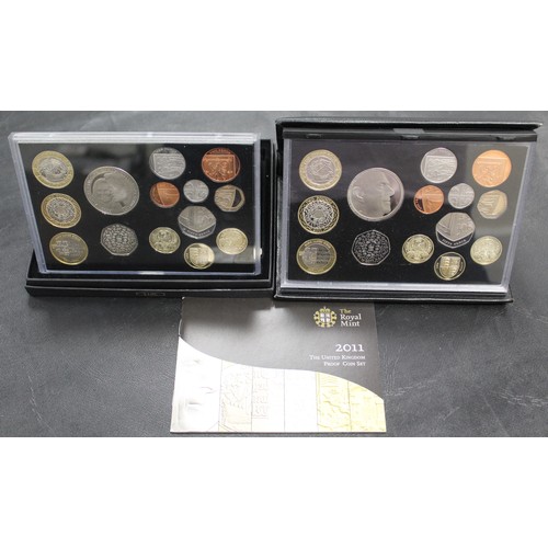 289 - A pair of 2011 Royal Mint 14-coin proof sets comprising original set in black leather case with Mary... 