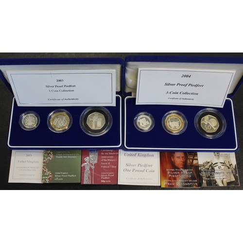 295 - 2003 & 2004 Silver proof piedfort 3-coin sets in blue presentation cases. Some minor toning othe... 