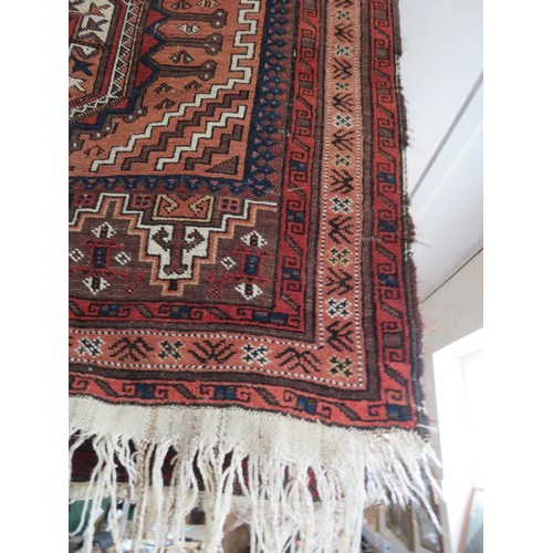 163 - A red ground rug approx 228cm x 106cm