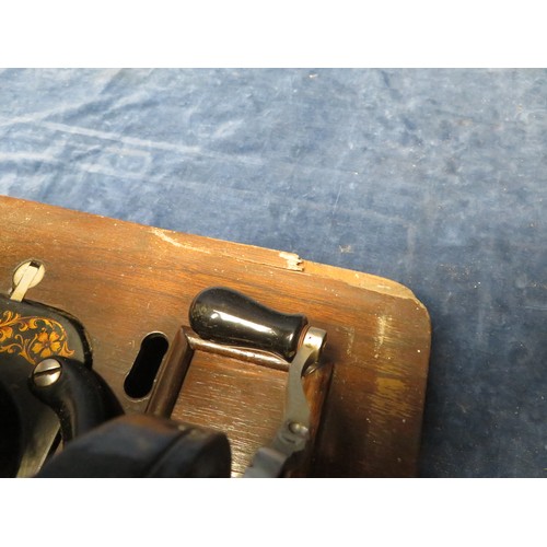 174 - A vintage Faudel's Ltd manual sewing machine in wooden carry case