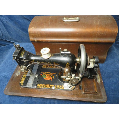 174 - A vintage Faudel's Ltd manual sewing machine in wooden carry case