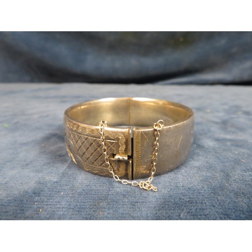 210 - A silver bangle with etched decoration, hallmarked and marked 