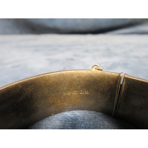 210 - A silver bangle with etched decoration, hallmarked and marked 