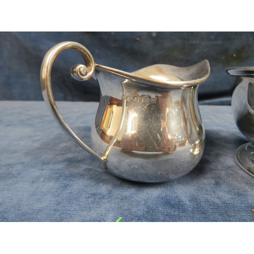 216 - A silver sugar bowl and cream jug, hallmarked Sheffield and stamped 