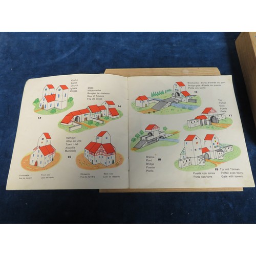 219 - A vintage Swiss wooden block construction toy with instruction manual.