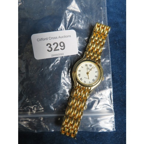 329 - A gold coloured metal ladies wrist watch with quartz movement.