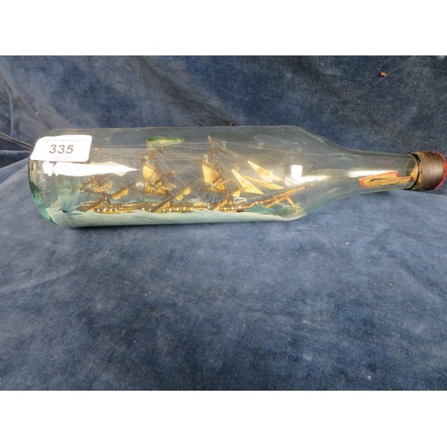 335 - An antique glass bottle containing a model of a 3 mast ship - 30 cm long