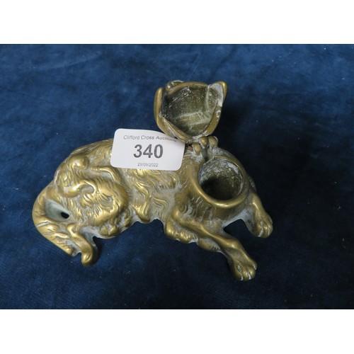 340 - A late 19th century cast brass laying spaniel inkwell (porcelain liner missing)