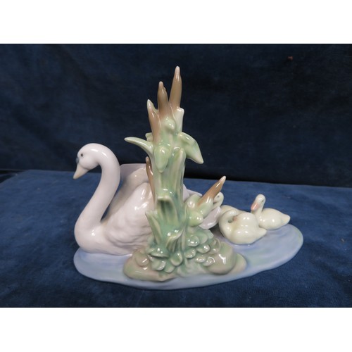 352 - A Llladro figurine depicting 'Swan and Cygnets'.