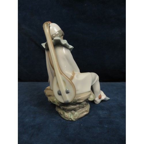 361 - A Lladro NAO figurine depicting 'Boy in Pierrot Costume'.