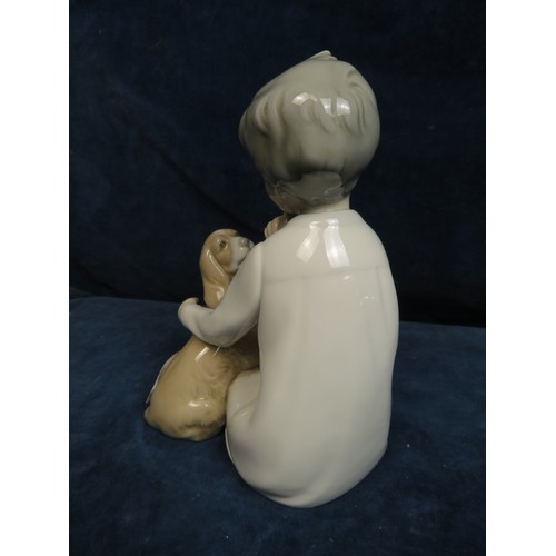 362 - A Lladro figurine depicting a 'Girl with a Dog'.