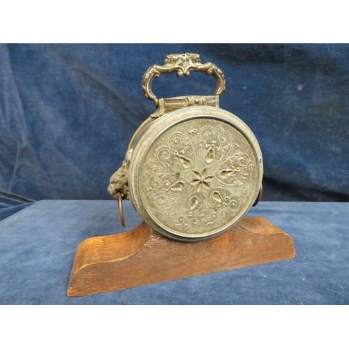 409 - A mantel clock in brass case with lion head handles, stamped 