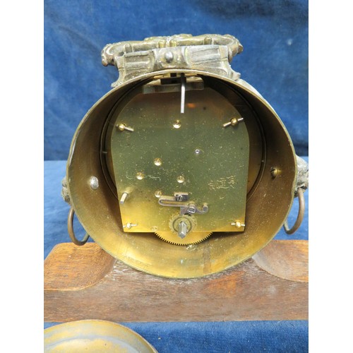 409 - A mantel clock in brass case with lion head handles, stamped 