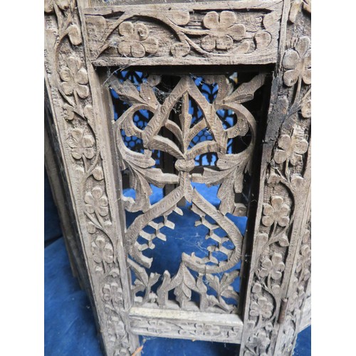 438 - An Octagonal side table with ornately carved eastern style floral decoration A/F.