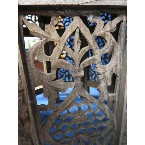 438 - An Octagonal side table with ornately carved eastern style floral decoration A/F.