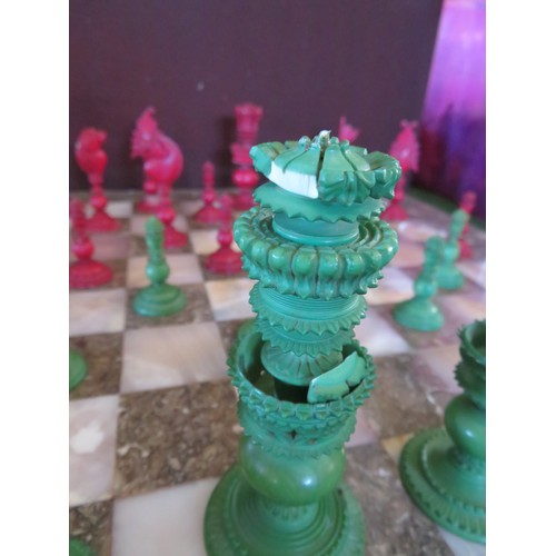 461 - A vintage chess set with marble playing board and ornately carved chess pieces A/F.