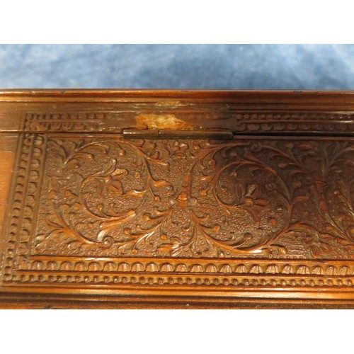 467 - An ornately carved Sandal Wood box, 48cm long x 10cm wide and 8cm high with key, some missing beadin... 