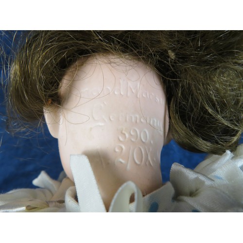 492 - An antique porcelain faced doll marked 