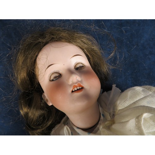 492 - An antique porcelain faced doll marked 