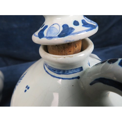 517 - A Delft ware bottle with cork stopper and a musical Delft ware bottle with cork stopper (A/F).