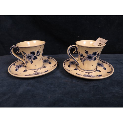 521 - Two Delft Ware cups and saucers with hand-painted decoration.