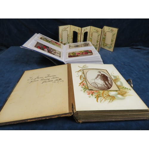 587 - An album of vintage and other postcards, a vintage album with decorative plates, and a further vinta... 