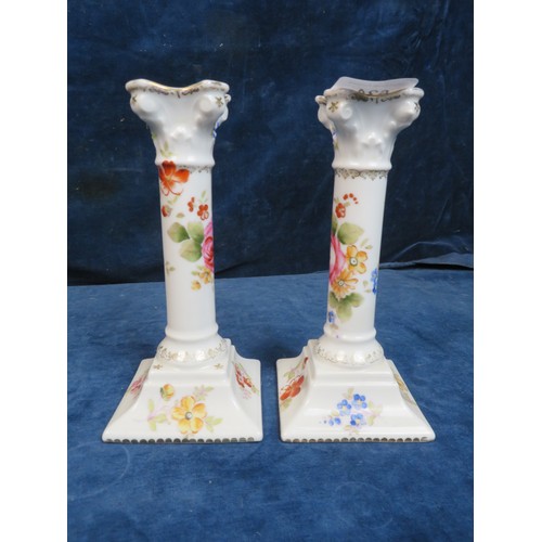 624 - A pair of continental porcelain candlesticks with floral decoration marked 136/2171, a pair of conti... 