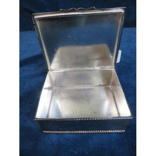 647 - A 20th century silver plated desk cigarette box inset with coin stamped 1821.