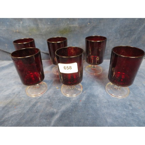 658 - Six red glass pedestal glasses.