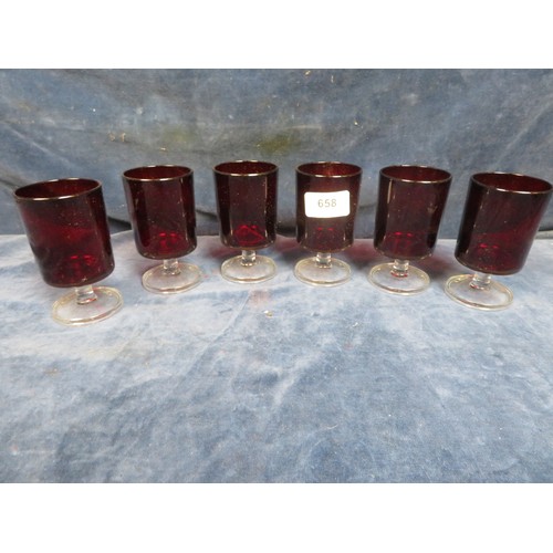 658 - Six red glass pedestal glasses.