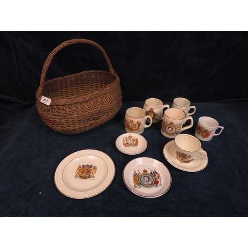 673 - A vintage wicker basket with a quantity of Royal Commemorative beakers, tea ware etc. including Coro... 