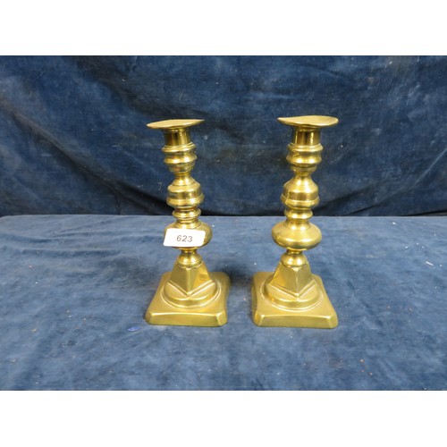 623 - A pair of brass candlesticks measuring 20cm high.