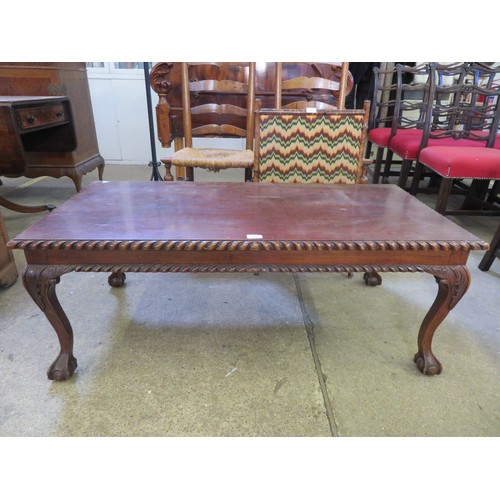 740 - A large 20th century coffee table on claw and ball feet.