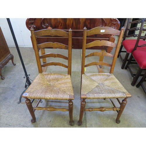 742 - A pair of antique ladder back country made chairs with woven rush seats.