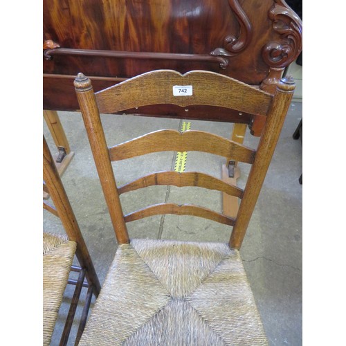 742 - A pair of antique ladder back country made chairs with woven rush seats.