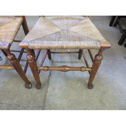 742 - A pair of antique ladder back country made chairs with woven rush seats.